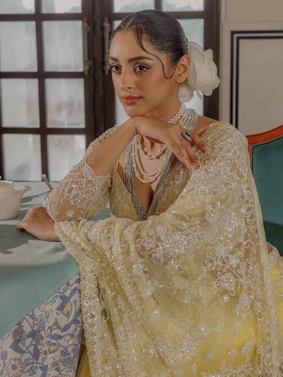 Yellow net saree for rich sequins work