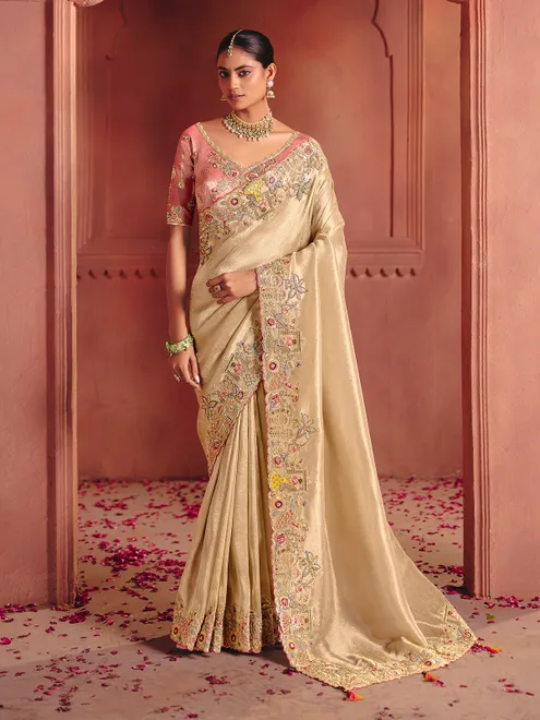 Beige bridal saree featuring exquisite traditional craftsmanship