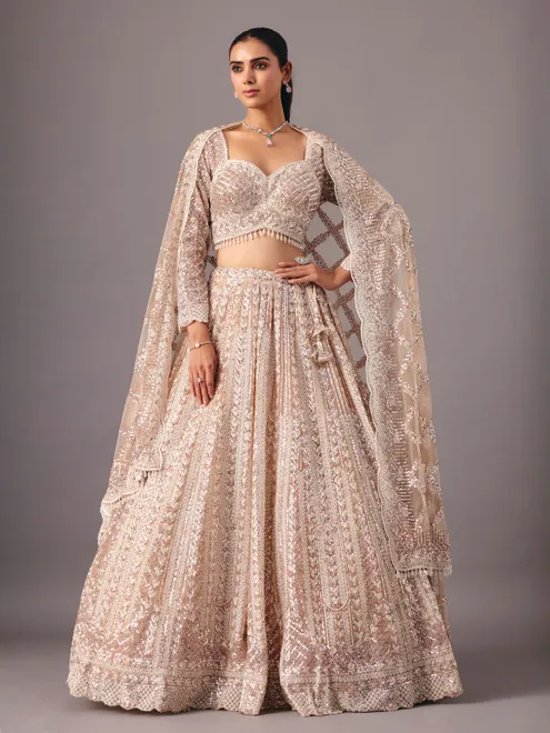 Beige net lehenga choli with pearl and sequin detailing