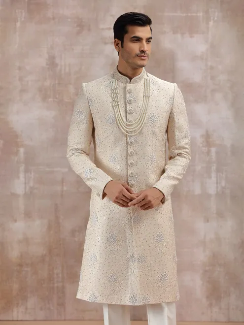 Beige silk sherwani highlighted with resham work