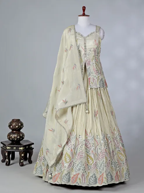 Cream silk lehenga choli with cowrie shells work