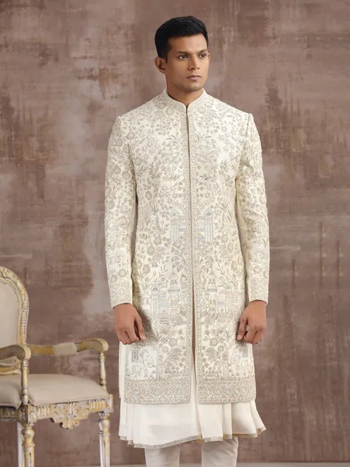 Cream silk peshwai sherwani with heavy embellishments