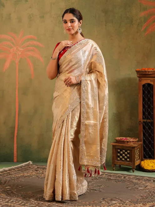 Cream silk saree for wedding celebration with red blouse