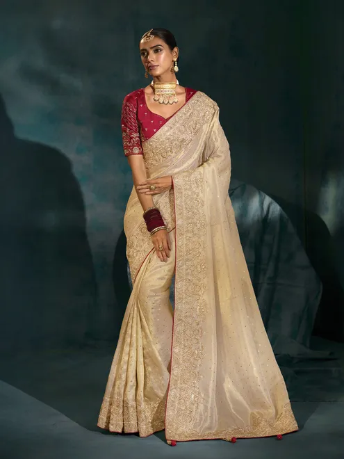 Cream silk wedding wear saree with bold maroon blouse