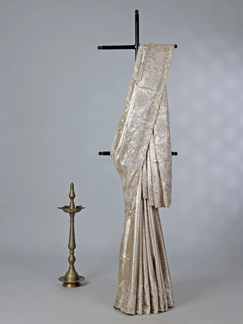 Golden tissue silk saree with bridal embellishments