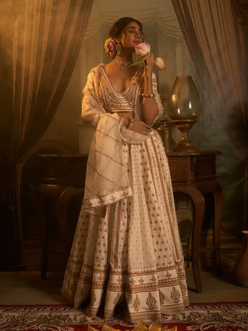 Off white silk wedding wear lehenga choli with beads detailing