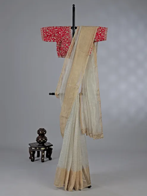 Off white tissue silk saree with elegant embellishments