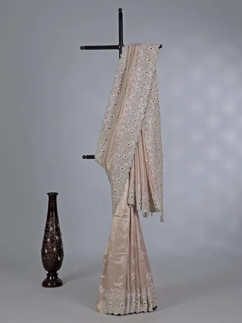 Off white tissue silk saree with sparkling stone and cutdana accents