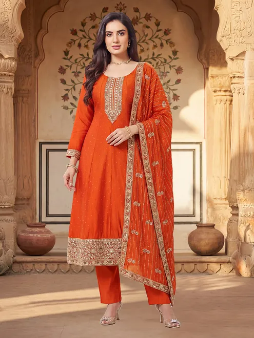 Orange silk salwar suit with heavy festive embellishment