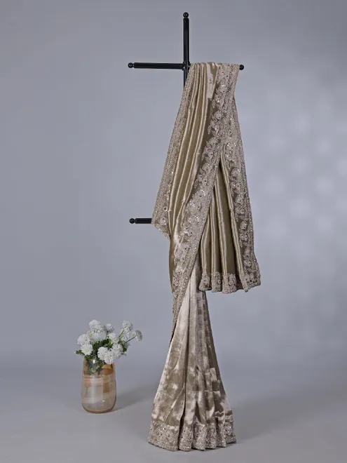 Pastel olive soft tissue silk saree with intricate festive embellishments