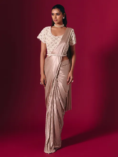 Pastel peach shimmer saree with elegant pearl embellishments