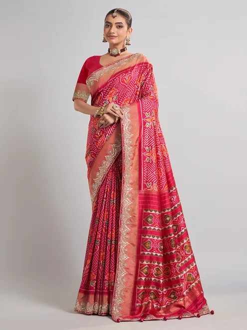 Rani pink patola silk saree with heavy bridal embellishments