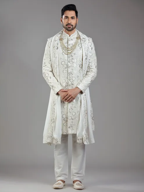 Royal splendor in cream silk with intricate embellishments and rich detailing
