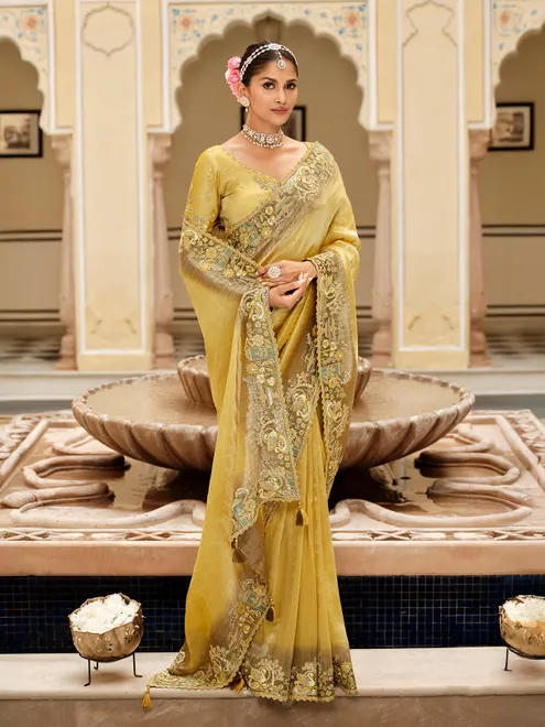 Yellow silk saree with rich embellished border