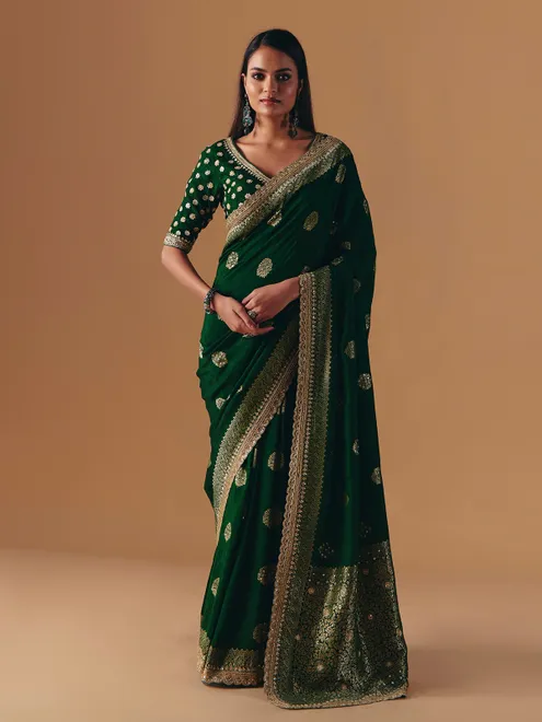 Dark green silk saree with heavy work blouse