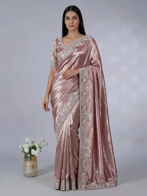 Pastel peach soft tissue silk saree with exquisite embellished work