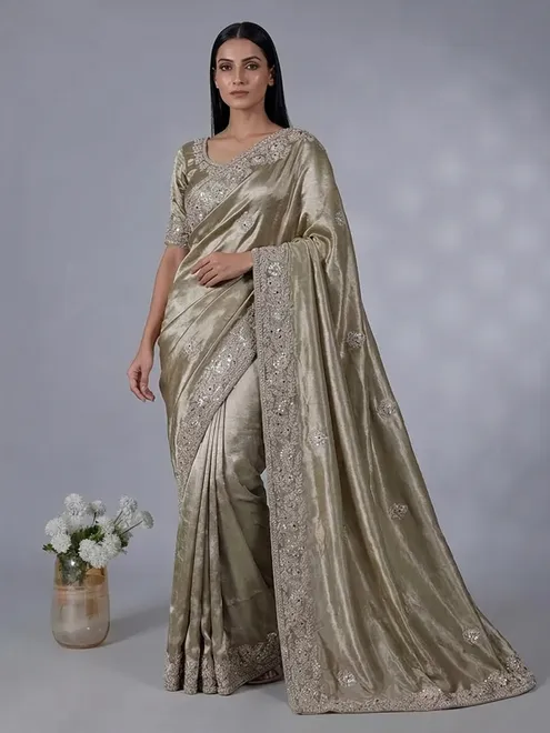 Pastel olive soft tissue silk saree with intricate festive embellishments