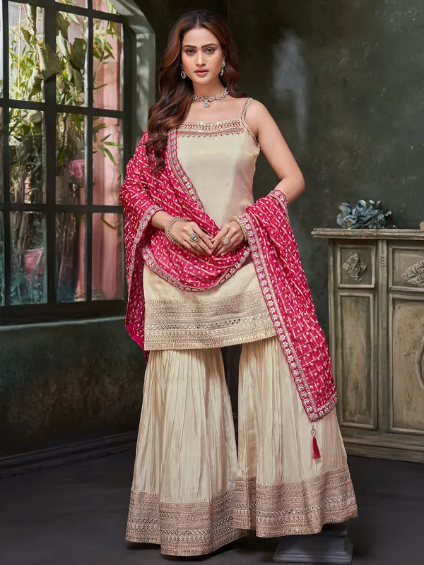 Beige silk salwar suit with bold red dupatta