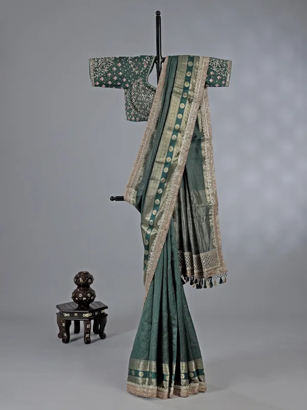 Bottle green dola silk saree with zari weaving