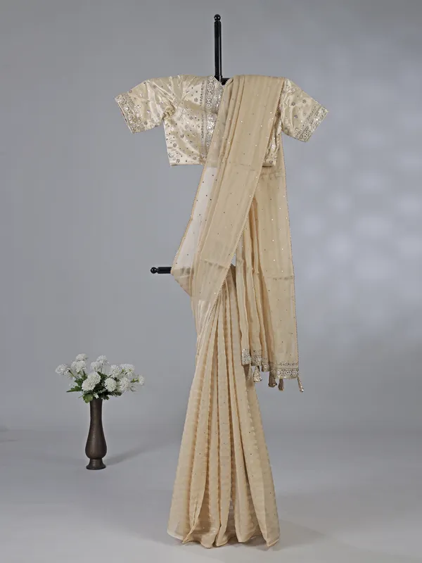 Cream organza saree with ready made blouse