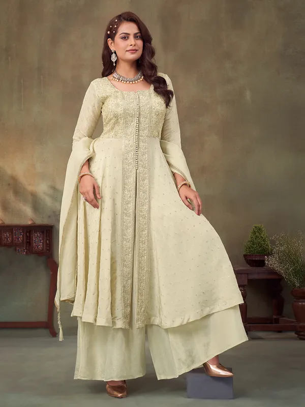 Cream pakistani silk suit with intricate embellishments for women