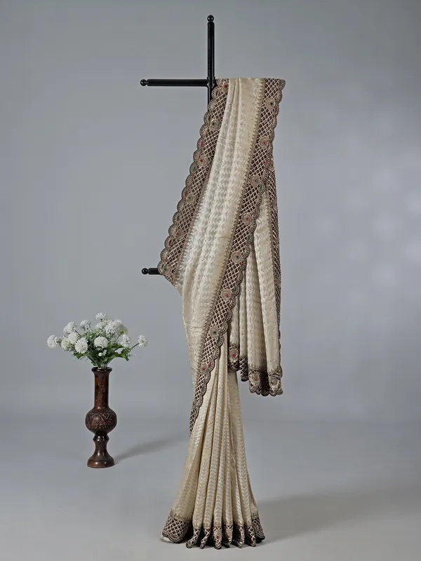 Cream silk saree with stone and zardosi work