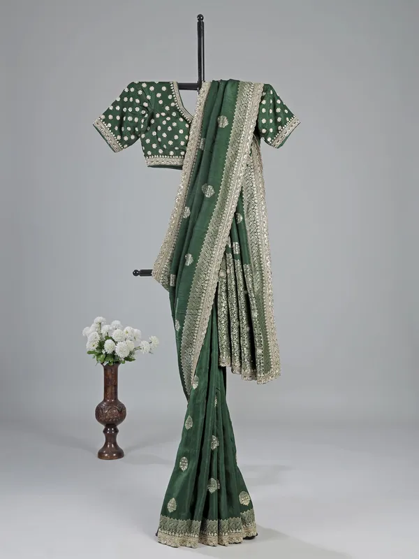 Dark green silk saree with heavy work blouse