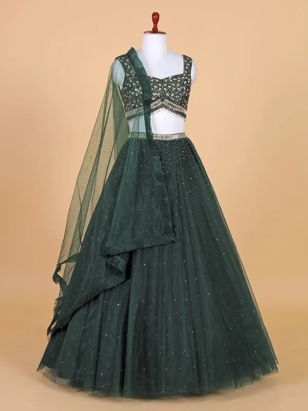 Fascinating dark green net lehenga choli