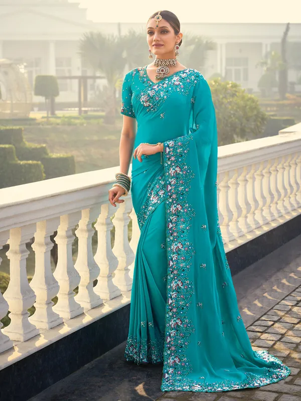 Firozi crape saree with graceful ethnic touch