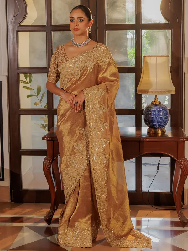 Gold silk saree with rich embellishment