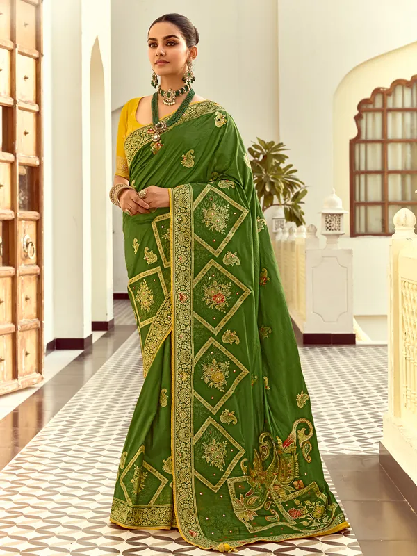 Green silk saree with colorful motif weaving