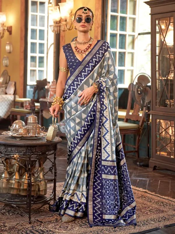 Grey silk printed saree with bold blue border