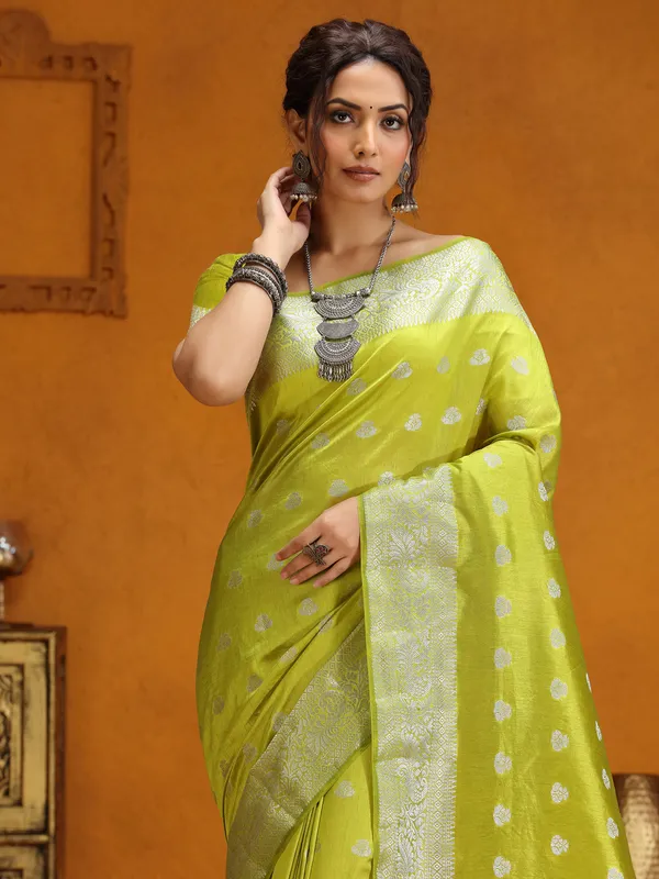 Lime green silk saree with silver zari weaving