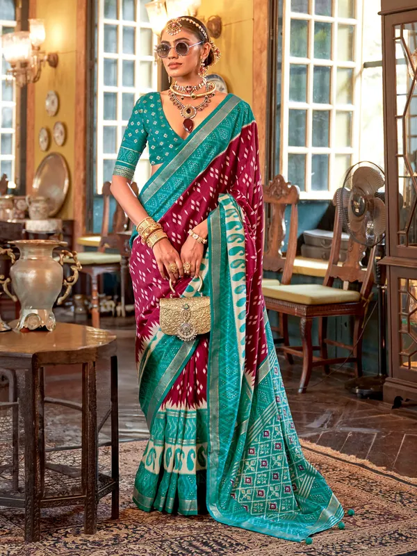 Maroon printed silk saree with contrast aqua border