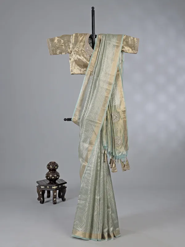 Mint green tissue silk saree with zari detailing