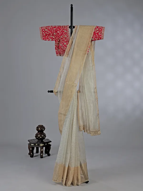 Off white tissue silk saree with elegant embellishments