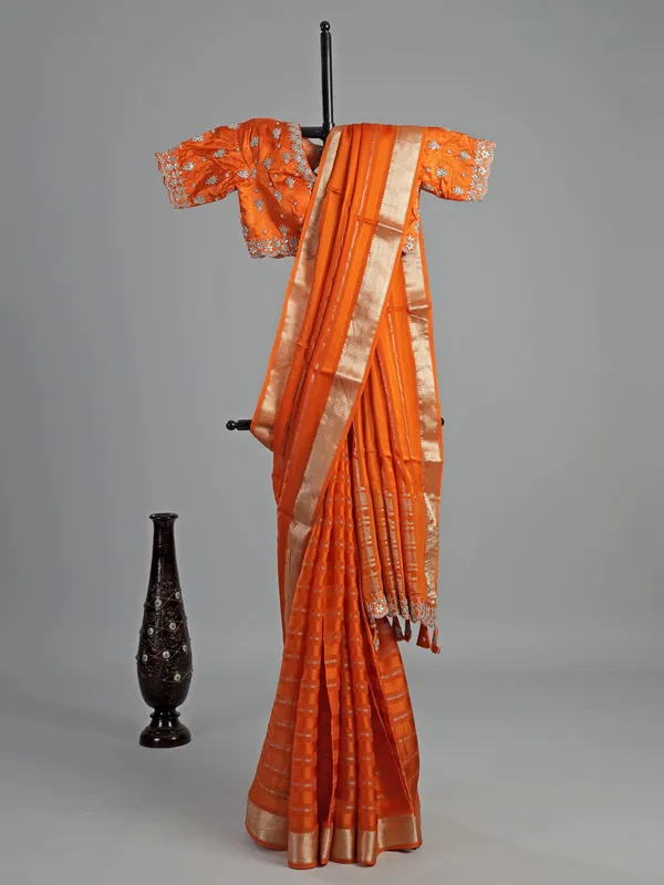 Orange organza satin saree with stone studded blouse