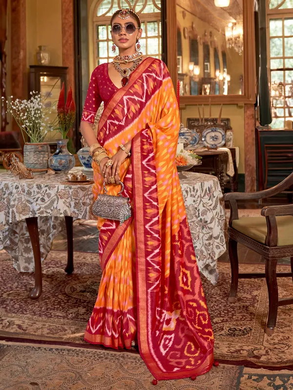 Orange printed silk saree with maroon pallu