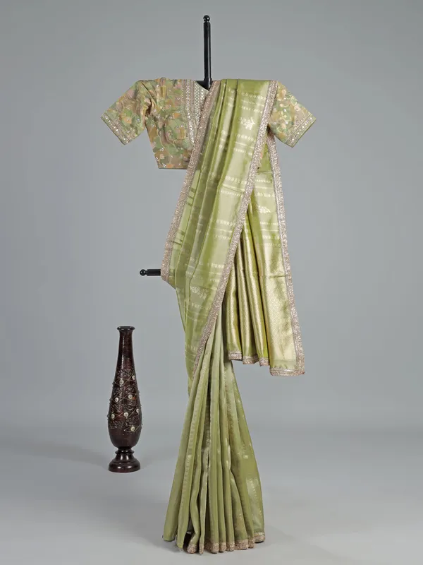 Pastel green soft tissue saree with sequin shine