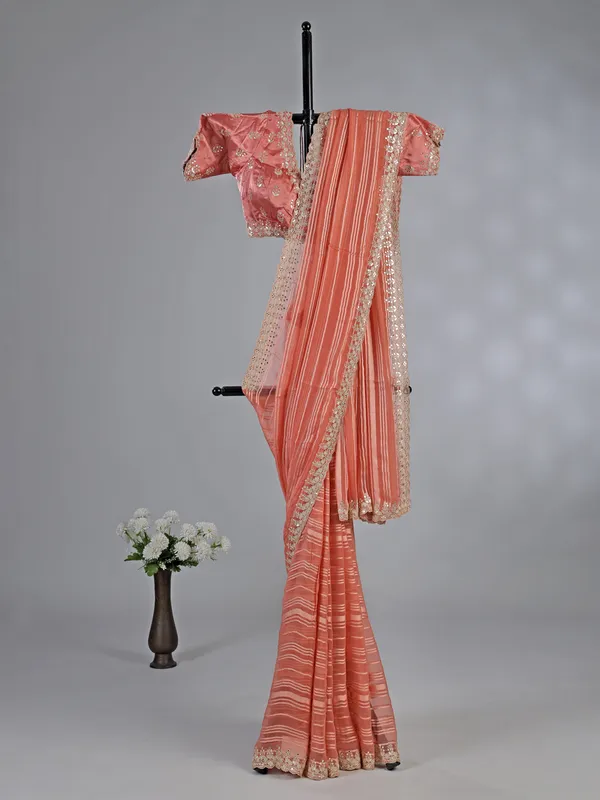 Peach organza satin silk saree with traditional embellishments