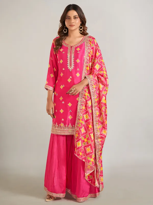 Rani color printed silk sharara suit with dupatta