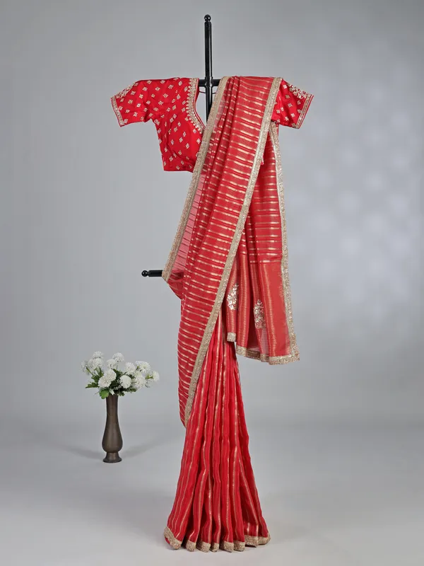 Red organza saree with traditional highlights