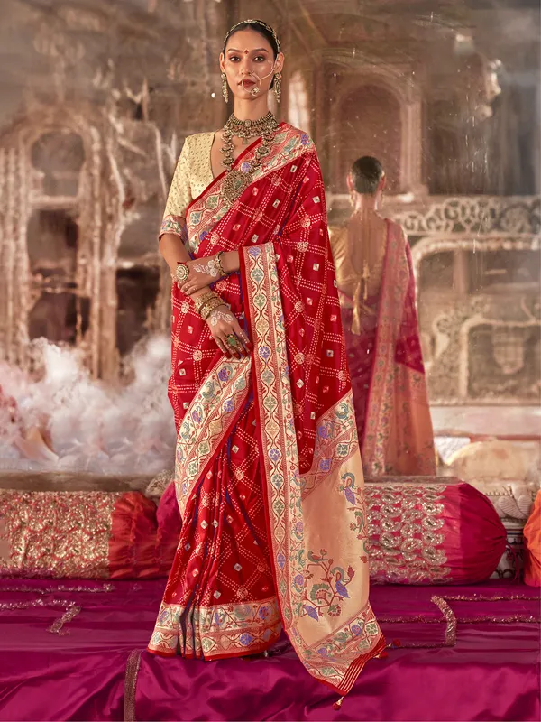 Red silk saree featuring luxe zari and print