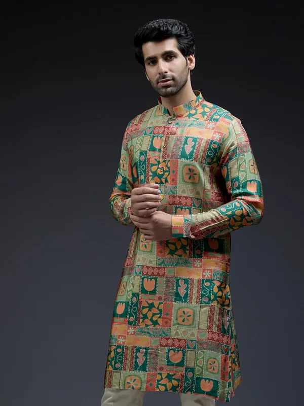 Rich silk green kurta suit in unique ethnic print