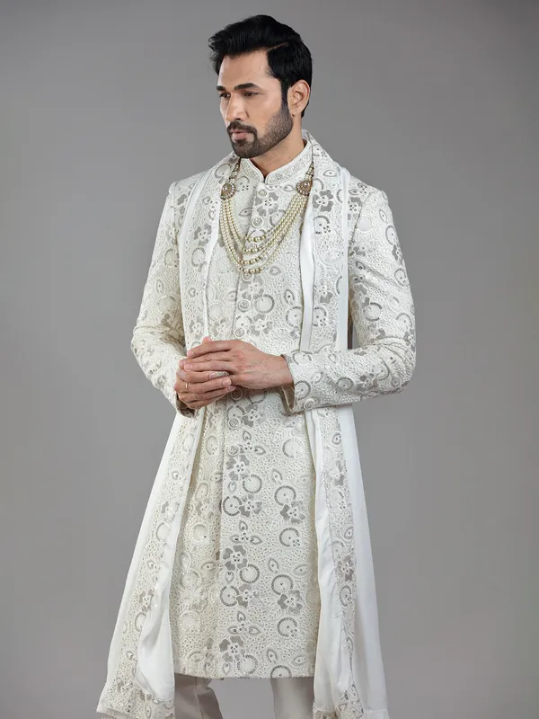 Royal splendor in cream silk with intricate embellishments and rich detailing