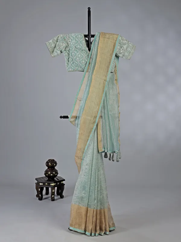 Sage green organza saree with zari weaving