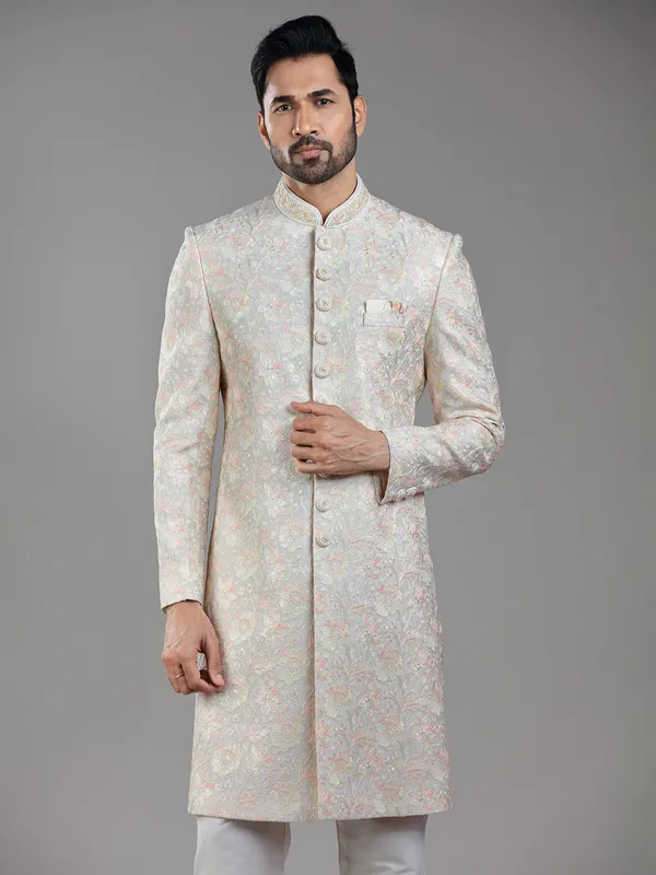 Timeless craftsmanship in grey raw silk with multi-colored embroidery