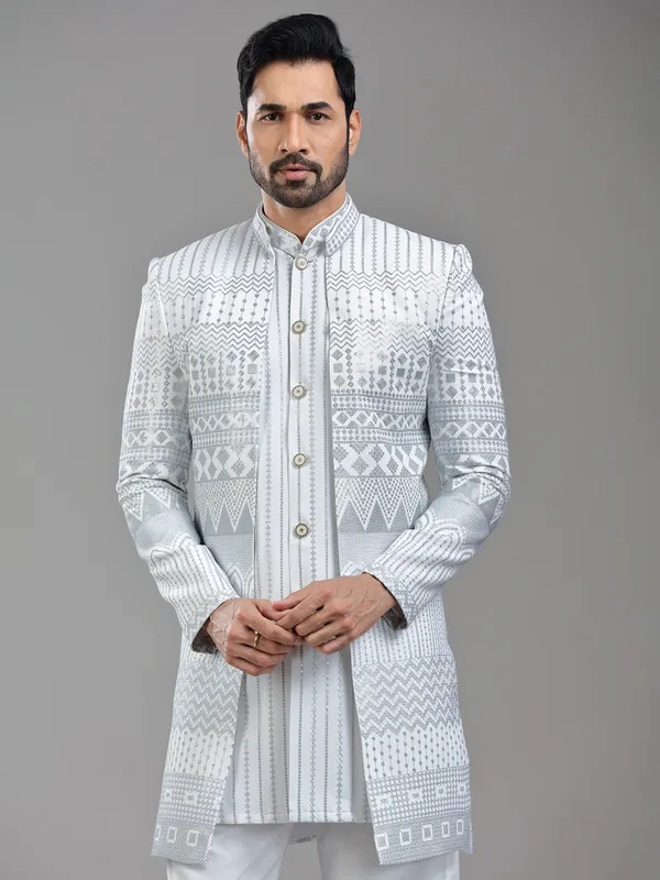 Vibrant white silk jacket style indowestern with sequins and resham work