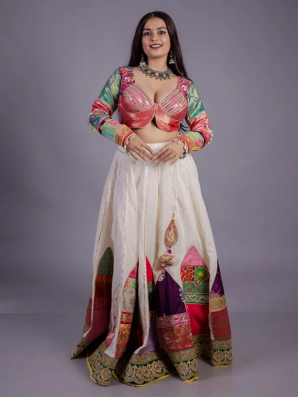 White silk lehenga choli with cowrie shell work