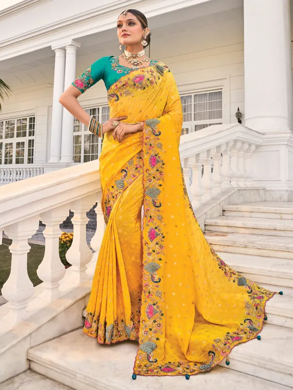 Yellow crape saree with rich festive appeal
